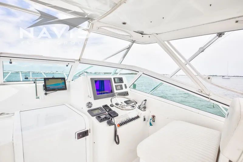 Pipe Dream Yacht Photos Pics Helm of 2005 Topaz 32 Express yacht with navigation equipment and ocean view.