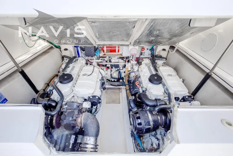 Pipe Dream Yacht Photos Pics Engine room of 2005 Topaz 32 Express yacht, featuring dual engines and mechanical components.