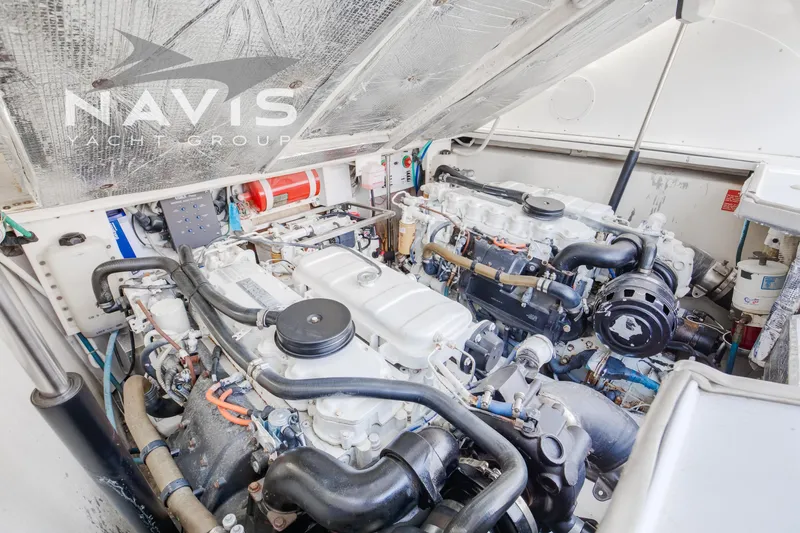 Pipe Dream Yacht Photos Pics Engine room of 2005 Topaz 32 Express yacht, featuring dual engines and mechanical components.