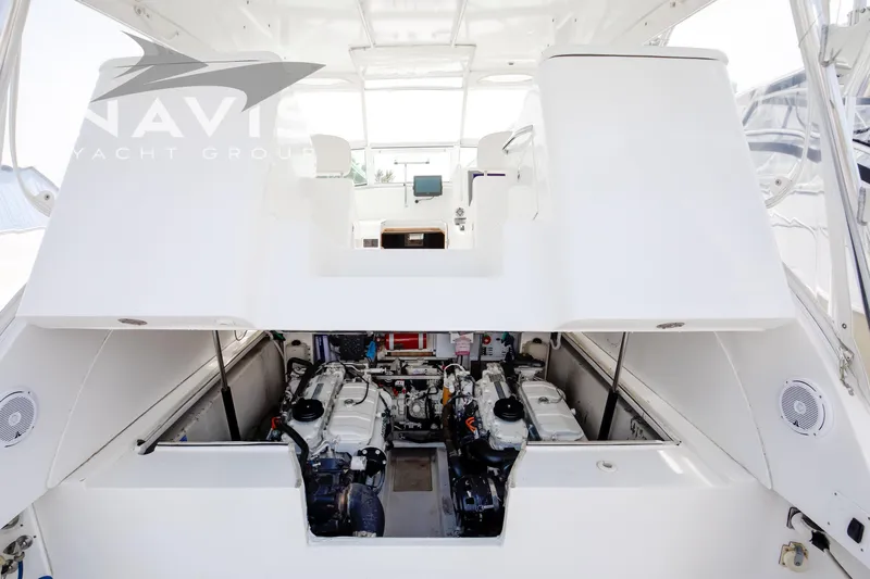 Pipe Dream Yacht Photos Pics 2005 Topaz 32 Express yacht engine compartment, showcasing dual engines and sleek interior design.