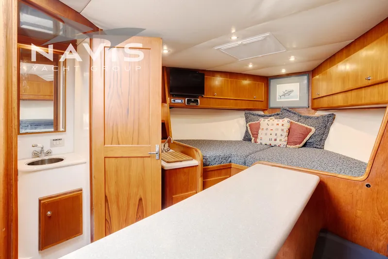 Pipe Dream Yacht Photos Pics Interior of 2005 Topaz 32 Express yacht with cozy cabin and wooden finishes.