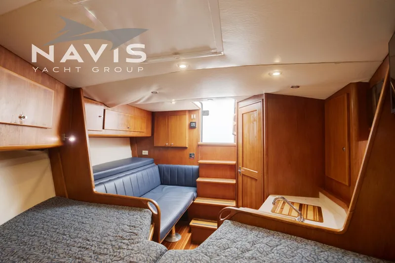 Pipe Dream Yacht Photos Pics Interior of 2005 Topaz 32 Express yacht with wooden cabinetry and seating.