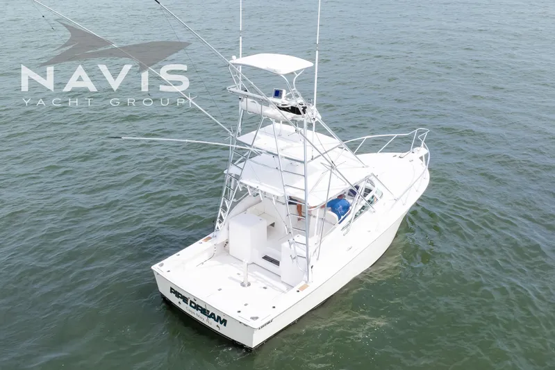 Pipe Dream Yacht Photos Pics 2005 Topaz 32 Express yacht on open water, Navis Yacht Group branding visible.