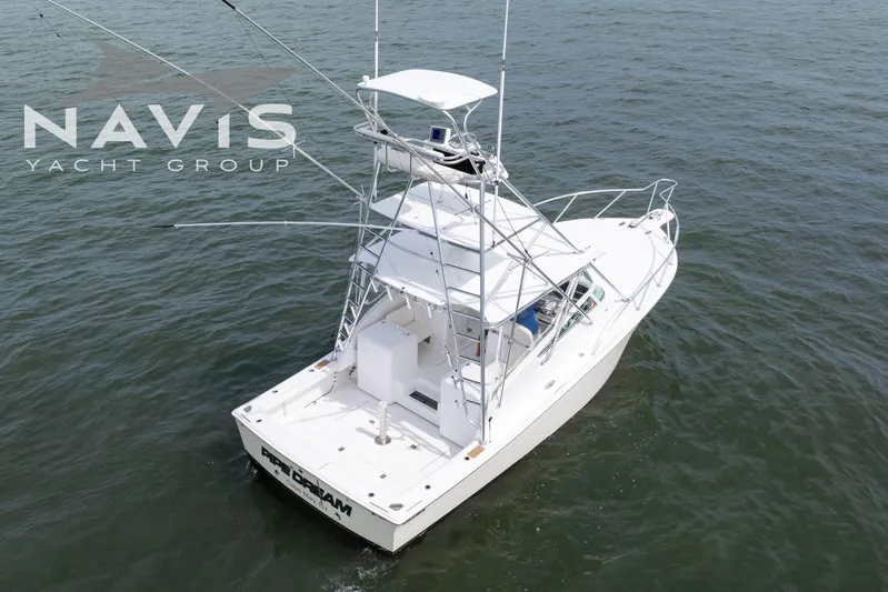 Pipe Dream Yacht Photos Pics 2005 Topaz 32 Express yacht on open water, featuring a sleek design and tower.