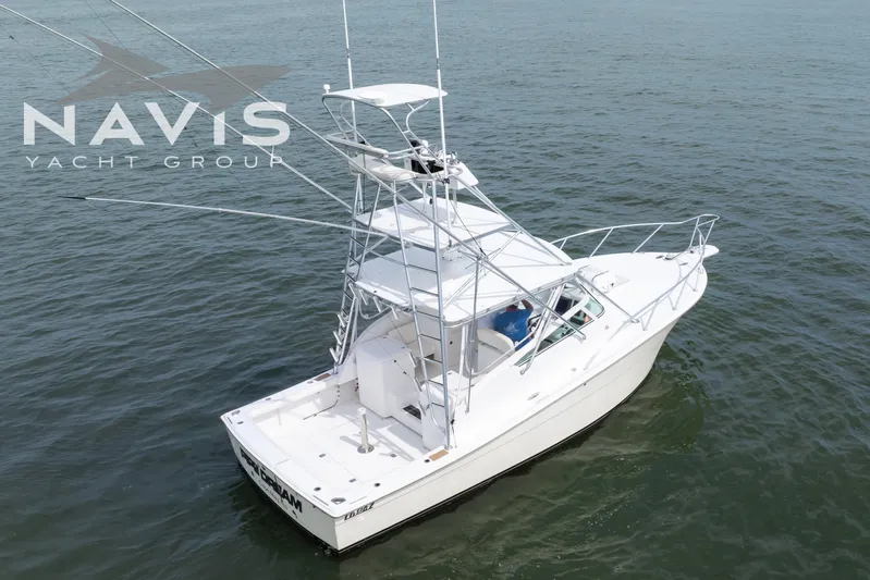 Pipe Dream Yacht Photos Pics 2005 Topaz 32 Express yacht on water, featuring sleek design and fishing tower.