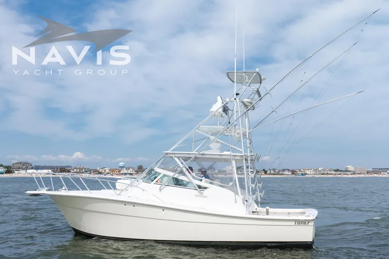 Pipe Dream Yacht Photos Pics 2005 Topaz 32 Express yacht on water, Navis Yacht Group branding visible.