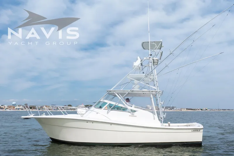 Pipe Dream Yacht Photos Pics 2005 Topaz 32 Express yacht on water, clear sky, Navis Yacht Group logo.