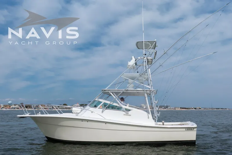 Pipe Dream Yacht Photos Pics 2005 Topaz 32 Express yacht on water, Navis Yacht Group logo visible.