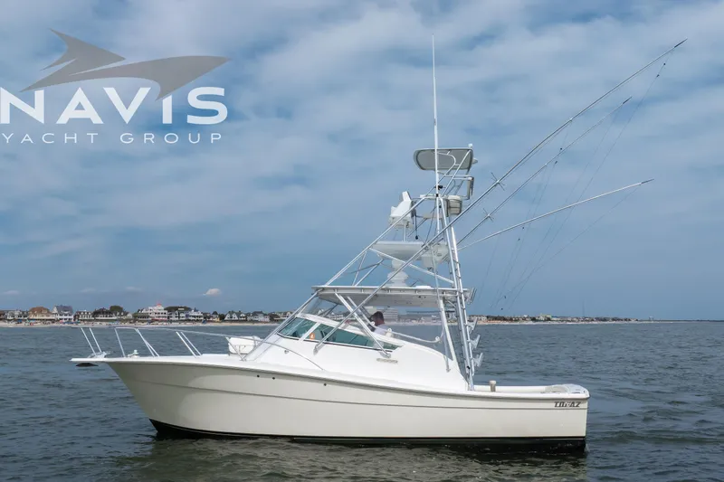 Pipe Dream Yacht Photos Pics 2005 Topaz 32 Express yacht on calm waters under a clear sky.