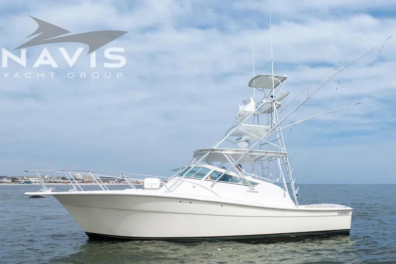 Pipe Dream Yacht Photos Pics 2005 Topaz 32 Express yacht on calm sea under cloudy sky.