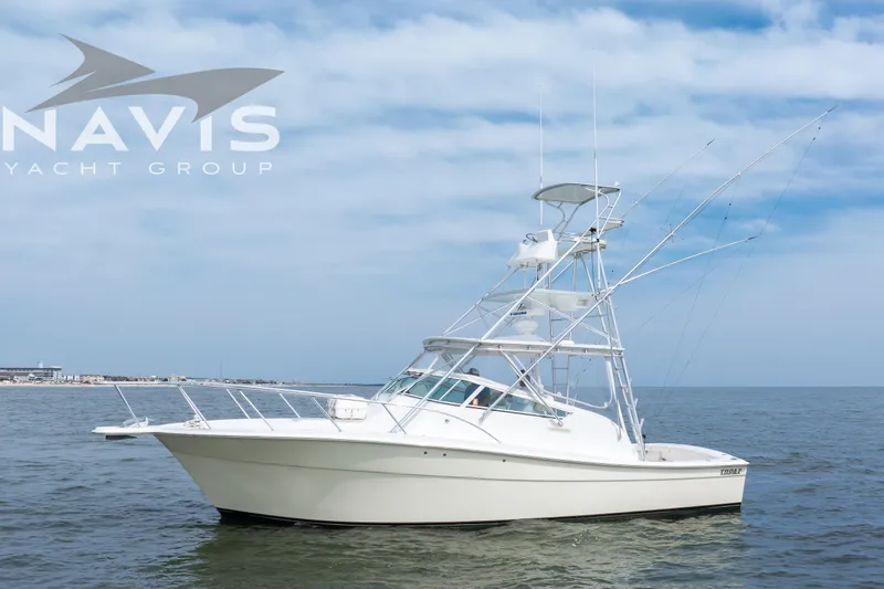 Pipe Dream Yacht Photos Pics 2005 Topaz 32 Express yacht on calm sea under blue sky.