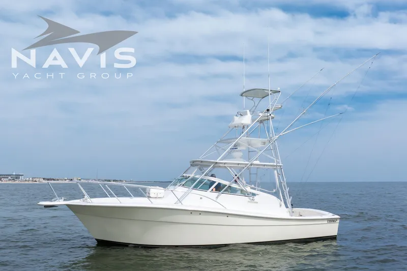 Pipe Dream Yacht Photos Pics 2005 Topaz 32 Express yacht on open water under a cloudy sky.