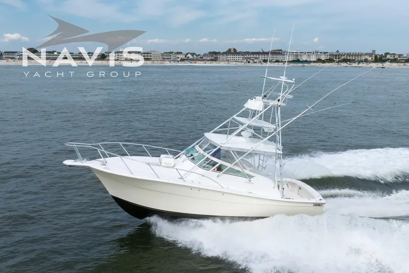 Pipe Dream Yacht Photos Pics 2005 Topaz 32 Express yacht cruising on open water, Navis Yacht Group logo visible.