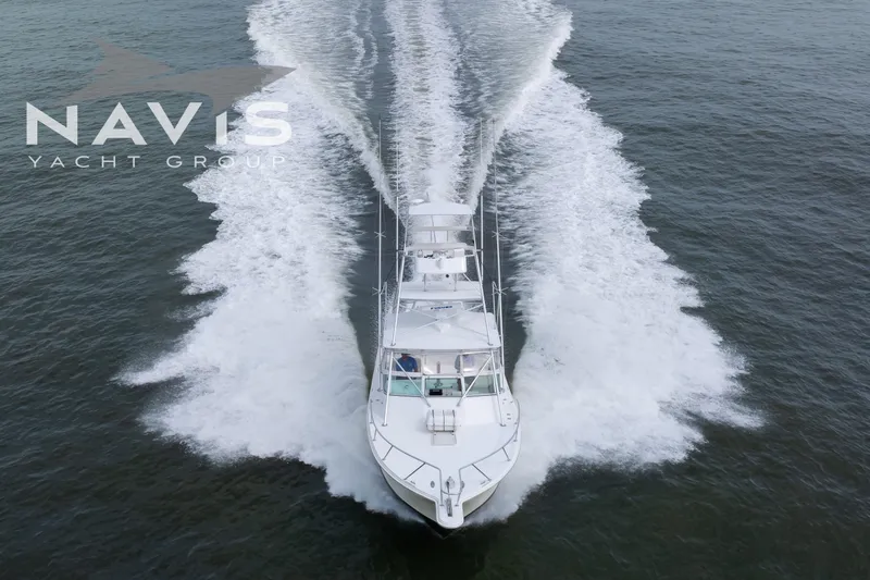 Pipe Dream Yacht Photos Pics 2005 Topaz 32 Express yacht cruising on open water, aerial view.