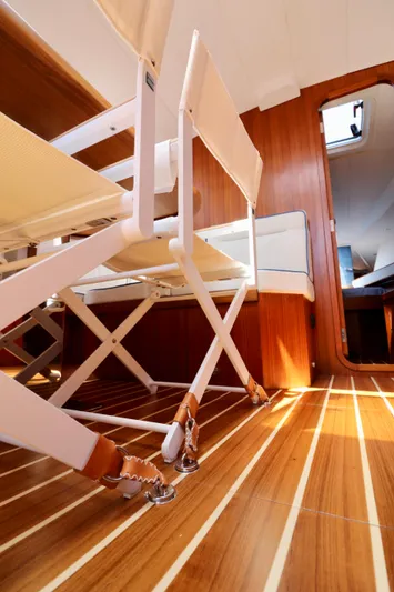  Yacht Photos Pics Interior of 2022 Jezequel Design 45 Classic yacht with wooden flooring and white seating.