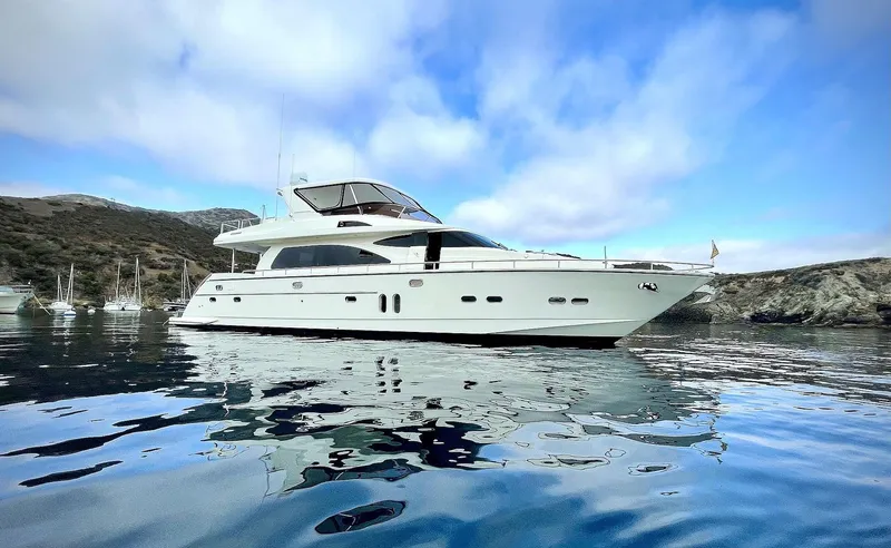Stella Maris II Yacht Photos Pics 2007 Horizon 73 Motor Yacht on calm water with scenic background.