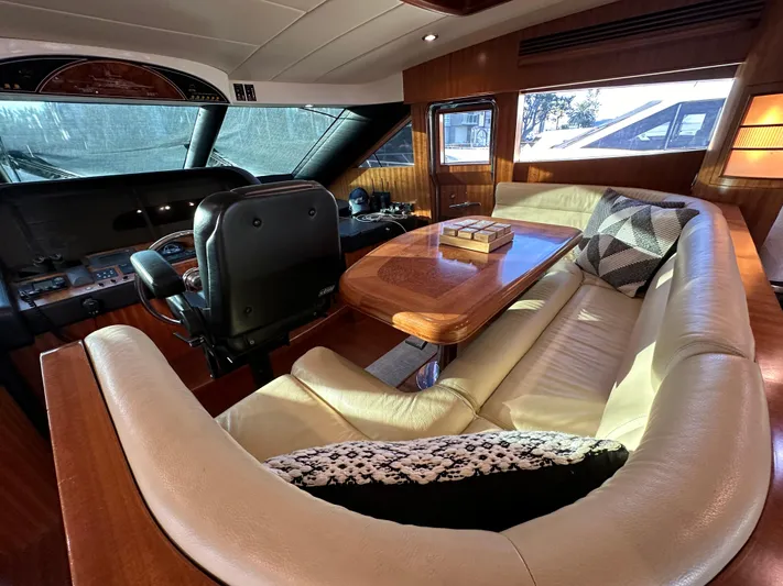 Stella Maris II Yacht Photos Pics Luxurious interior of 2007 Horizon 73 Motor Yacht with leather seating and wooden table.