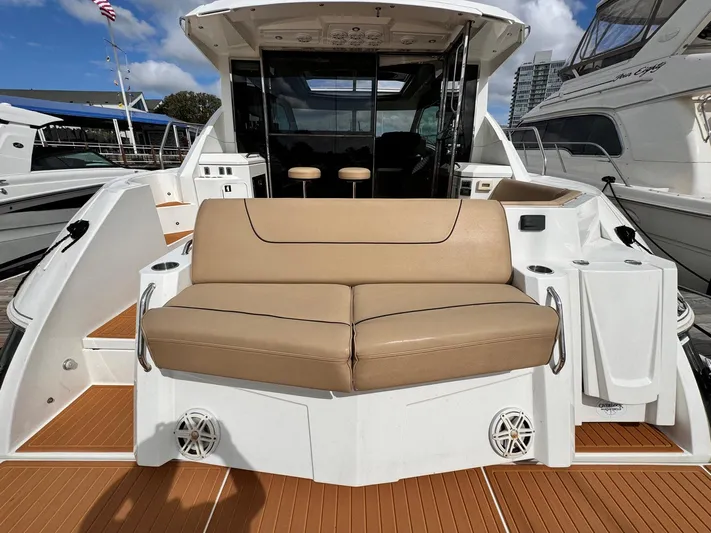  Yacht Photos Pics 2014 Cruisers Yachts 45 Cantius with tan seating on deck, docked at marina.