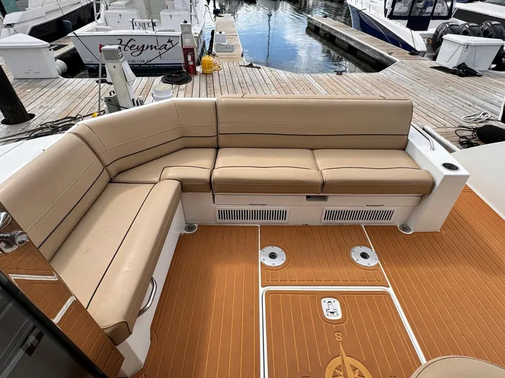  Yacht Photos Pics 2014 Cruisers Yachts 45 Cantius, beige seating, teak deck, docked at marina.