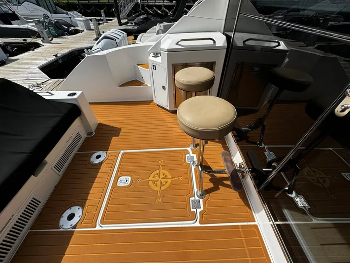  Yacht Photos Pics 2014 Cruisers Yachts 45 Cantius deck with stools and wood flooring.