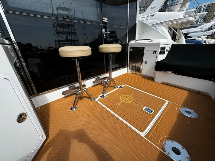  Yacht Photos Pics 2014 Cruisers Yachts 45 Cantius deck with bar stools and teak flooring.