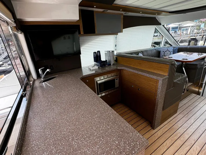  Yacht Photos Pics Interior of 2014 Cruisers Yachts 45 Cantius with modern kitchen and seating area.