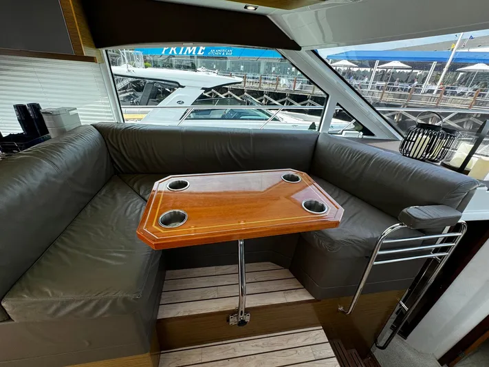  Yacht Photos Pics Luxurious interior of 2014 Cruisers Yachts 45 Cantius with leather seating and wooden table.