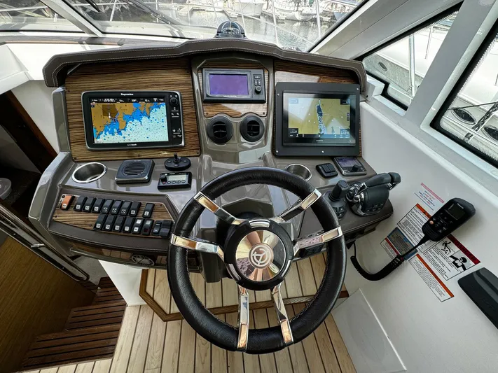  Yacht Photos Pics Helm of 2014 Cruisers Yachts 45 Cantius with navigation screens and controls.