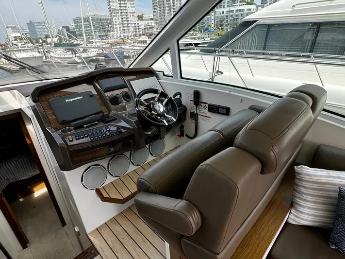  Yacht Photos Pics 2014 Cruisers Yachts 45 Cantius helm with leather seats and modern controls.