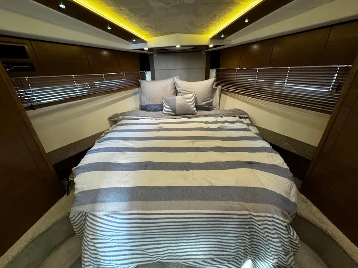  Yacht Photos Pics Luxurious bedroom interior of 2014 Cruisers Yachts 45 Cantius with striped bedding.
