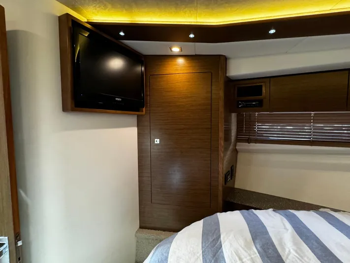  Yacht Photos Pics Interior of 2014 Cruisers Yachts 45 Cantius with TV, wood paneling, and cozy lighting.
