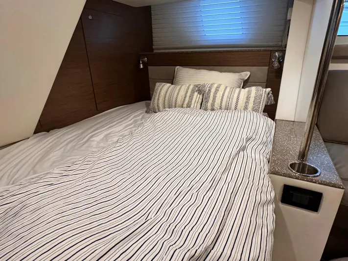  Yacht Photos Pics Luxurious bedroom interior of 2014 Cruisers Yachts 45 Cantius with striped bedding.