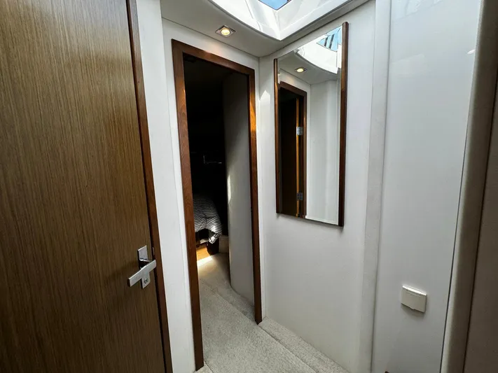  Yacht Photos Pics Hallway inside 2014 Cruisers Yachts 45 Cantius, featuring wooden doors and a wall mirror.