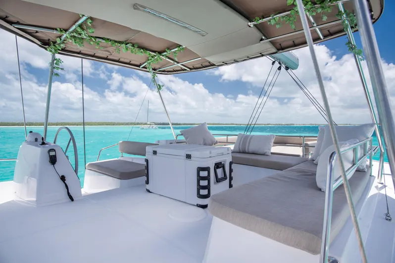 Bella Yacht Photos Pics Luxurious 2021 Bali 4.8 catamaran deck with seating, sailing on turquoise waters.
