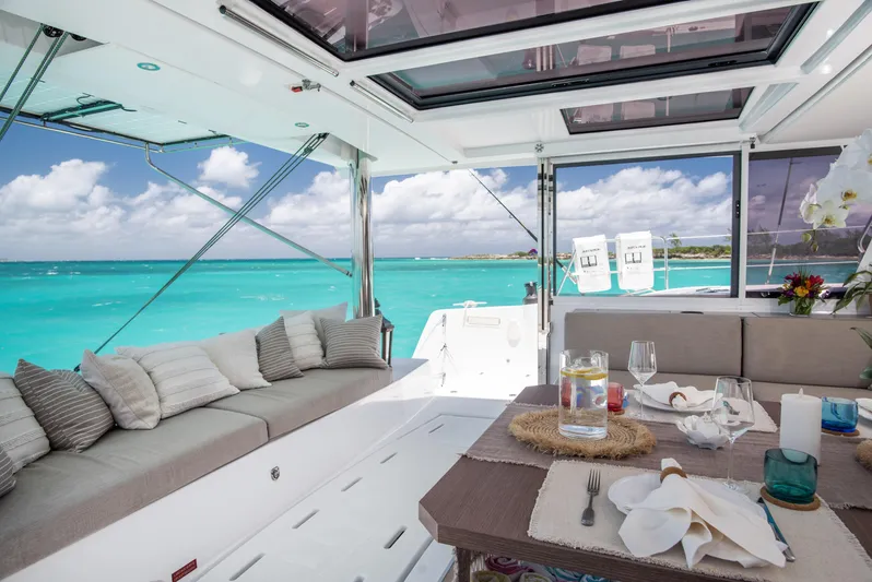 Bella Yacht Photos Pics Luxurious Bali 4.8 catamaran interior with ocean view, featuring elegant dining setup and comfortable seating.