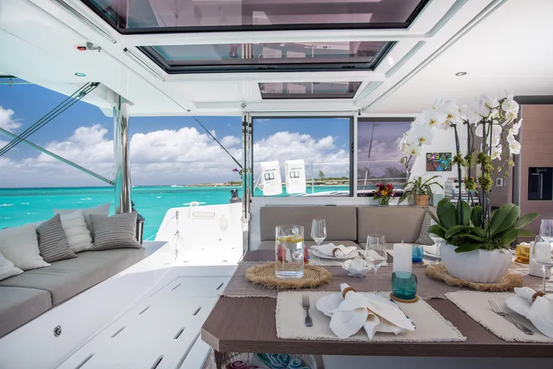 Bella Yacht Photos Pics Luxurious Bali 4.8 catamaran interior with elegant dining setup, overlooking turquoise ocean waters.