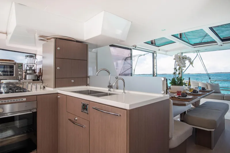 Bella Yacht Photos Pics Luxurious interior of 2021 Bali 4.8 catamaran with modern kitchen and dining area.