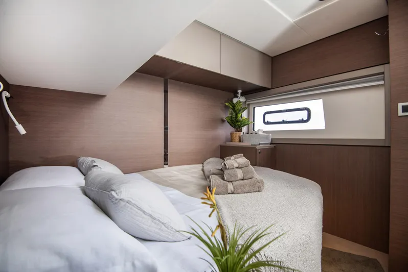 Bella Yacht Photos Pics Luxurious cabin interior of 2021 Bali 4.8 yacht with cozy bedding and modern decor.