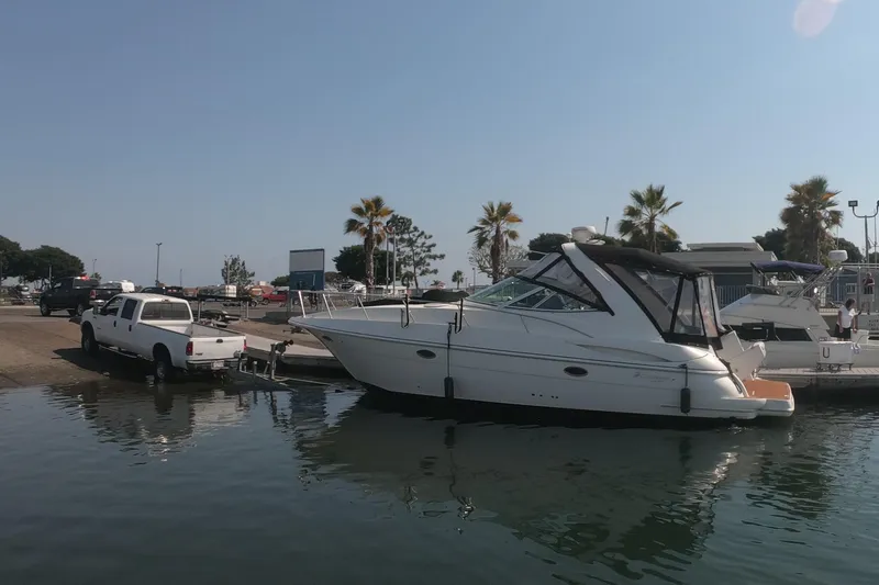Grand Cru Yacht Photos Pics 2005 Cruisers Yachts 340 Express being launched from a trailer at a marina.
