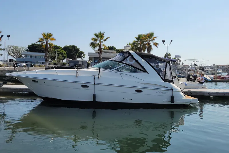 Grand Cru Yacht Photos Pics 2005 Cruisers Yachts 340 Express docked at marina with palm trees in background.