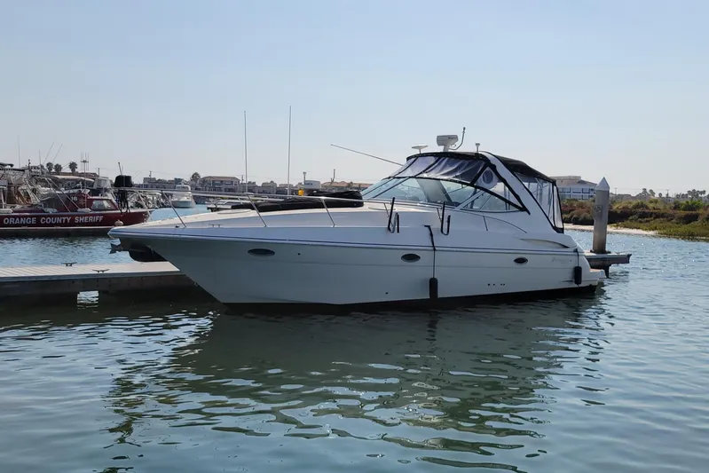Grand Cru Yacht Photos Pics 2005 Cruisers Yachts 340 Express docked in a marina under clear skies.