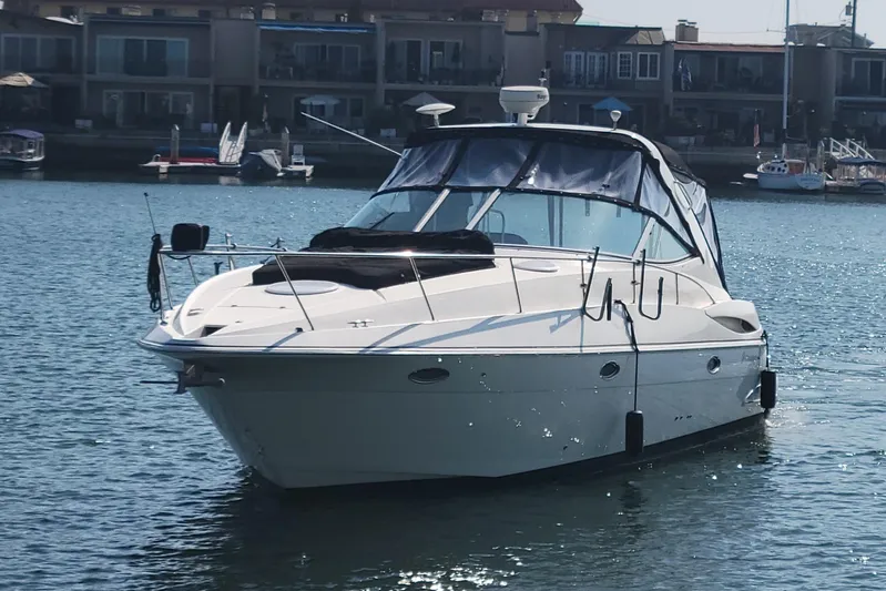Grand Cru Yacht Photos Pics 2005 Cruisers Yachts 340 Express boat on calm water near waterfront homes.