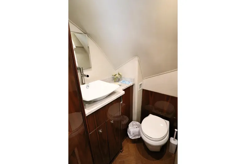 Stress Release Yacht Photos Pics Luxurious bathroom in 2017 Viking 80 Enclosed Bridge yacht with modern fixtures and wood accents.