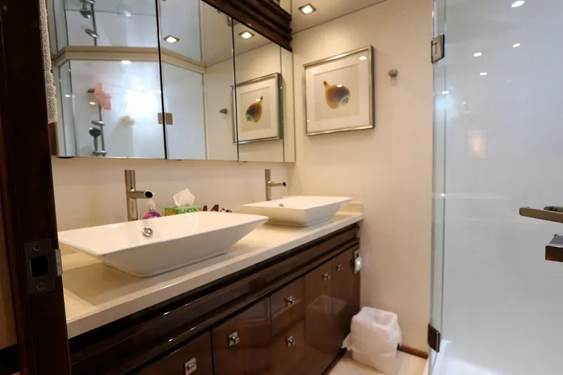 Stress Release Yacht Photos Pics Luxurious bathroom in 2017 Viking 80 Enclosed Bridge yacht with dual sinks and modern decor.