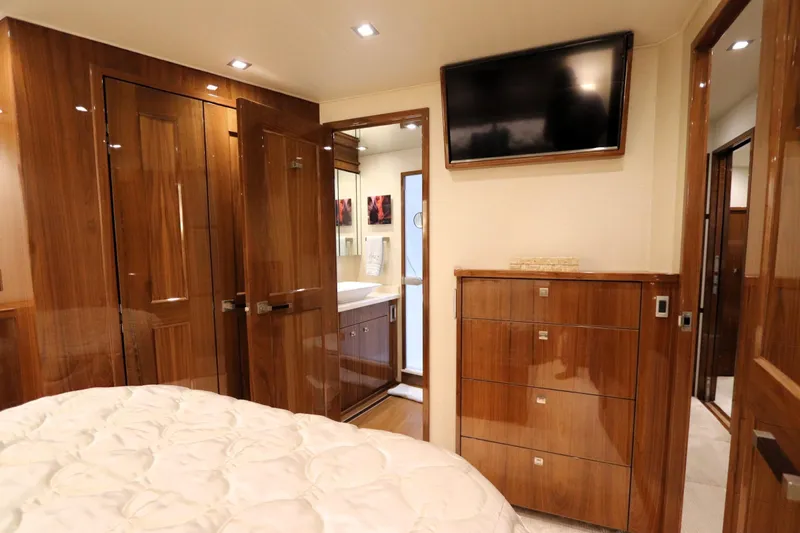 Stress Release Yacht Photos Pics Luxurious interior of 2017 Viking 80 Enclosed Bridge yacht with wood finishes and modern amenities.