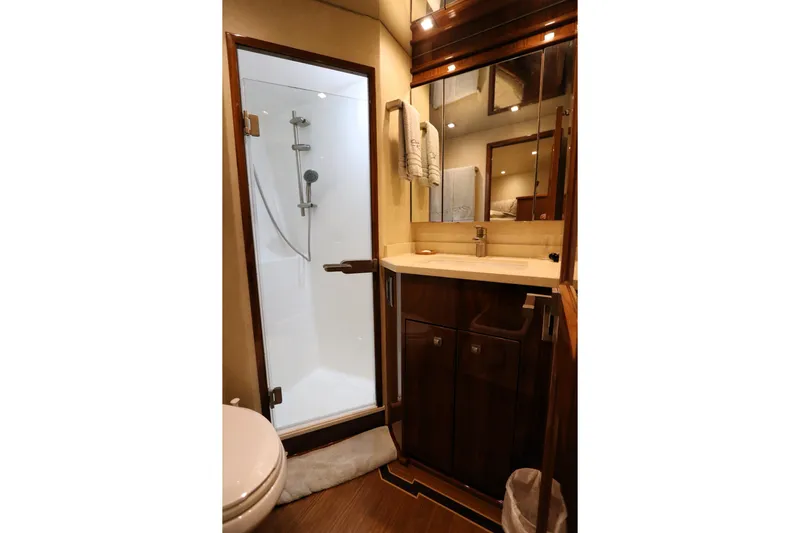 Stress Release Yacht Photos Pics Luxurious bathroom in 2017 Viking 80 Enclosed Bridge yacht with shower and vanity.