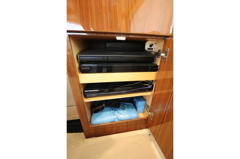 Stress Release Yacht Photos Pics Cabinet with electronic devices on a 2017 Viking 80 Enclosed Bridge yacht.
