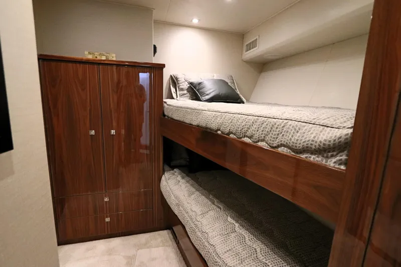 Stress Release Yacht Photos Pics 2017 Viking 80 Enclosed Bridge cabin with wooden bunk beds and storage.