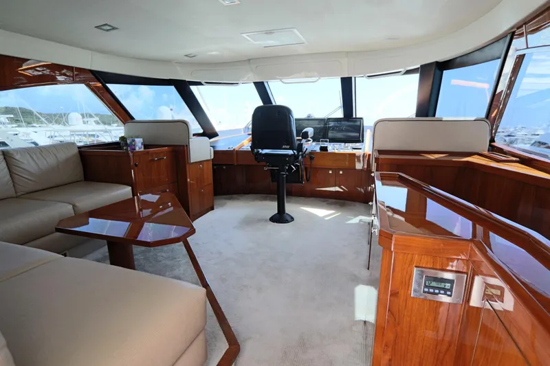 Stress Release Yacht Photos Pics Luxurious interior of 2017 Viking 80 Enclosed Bridge yacht with plush seating and helm.