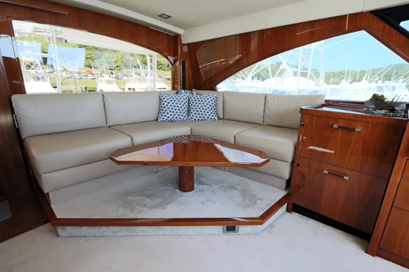 Stress Release Yacht Photos Pics Luxurious interior of 2017 Viking 80 Enclosed Bridge yacht with elegant seating and wooden accents.